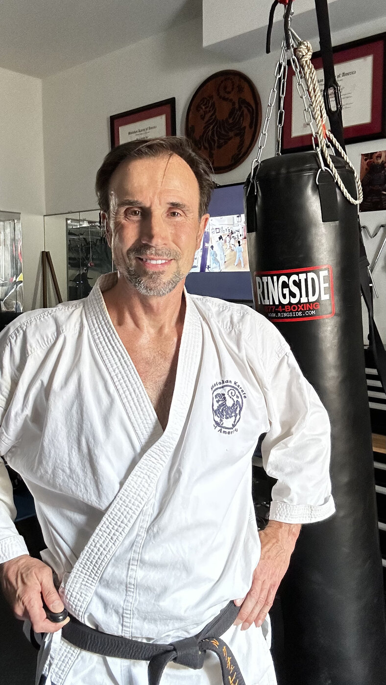 Shotokan karate instructor in gi and black belt at the private training space in San Diego